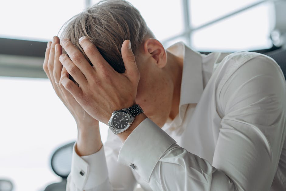 a-business-professional-showing-stress-and-fatigue-with-head