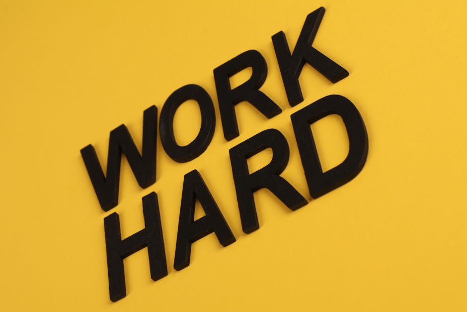 black-text-work-hard-on-a-vibrant-yellow-background-for-moti