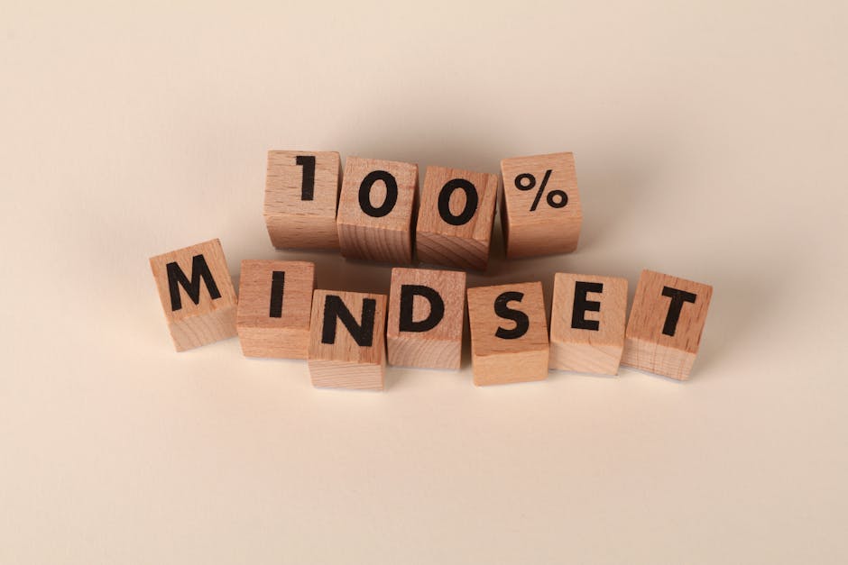 wooden-blocks-arranged-to-spell-100-mindset-on-a-neutral-bei